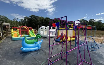 Grasshopper Farms Splash Park in Knightdale offering inflatable water slides, playgrounds, farm animals, and summer fun.